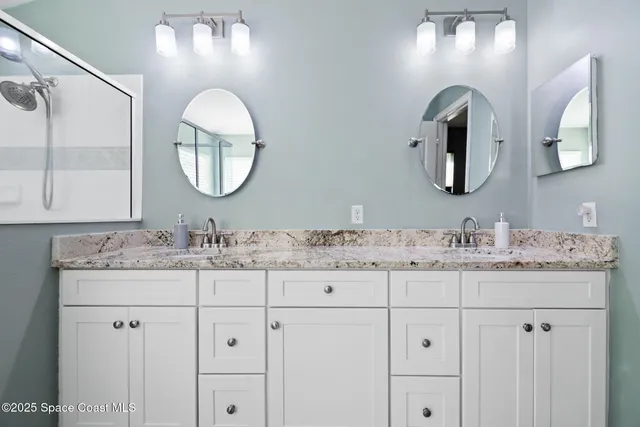 a white bath tub sitting in a bathroom next to a window