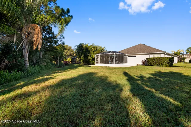 a view of a swimming pool with a yard and outdoor seating