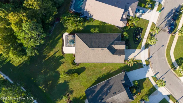 an aerial view of a house with a swimming pool outdoor seating and yard