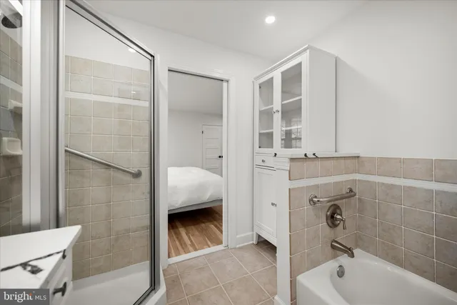 a bathroom with a bathtub and a shower