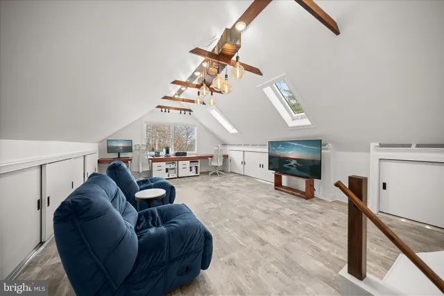 a living room with furniture a dining table and chairs with wooden floor