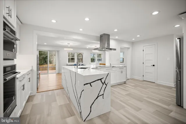 a kitchen with stainless steel appliances kitchen island granite countertop a sink and cabinets
