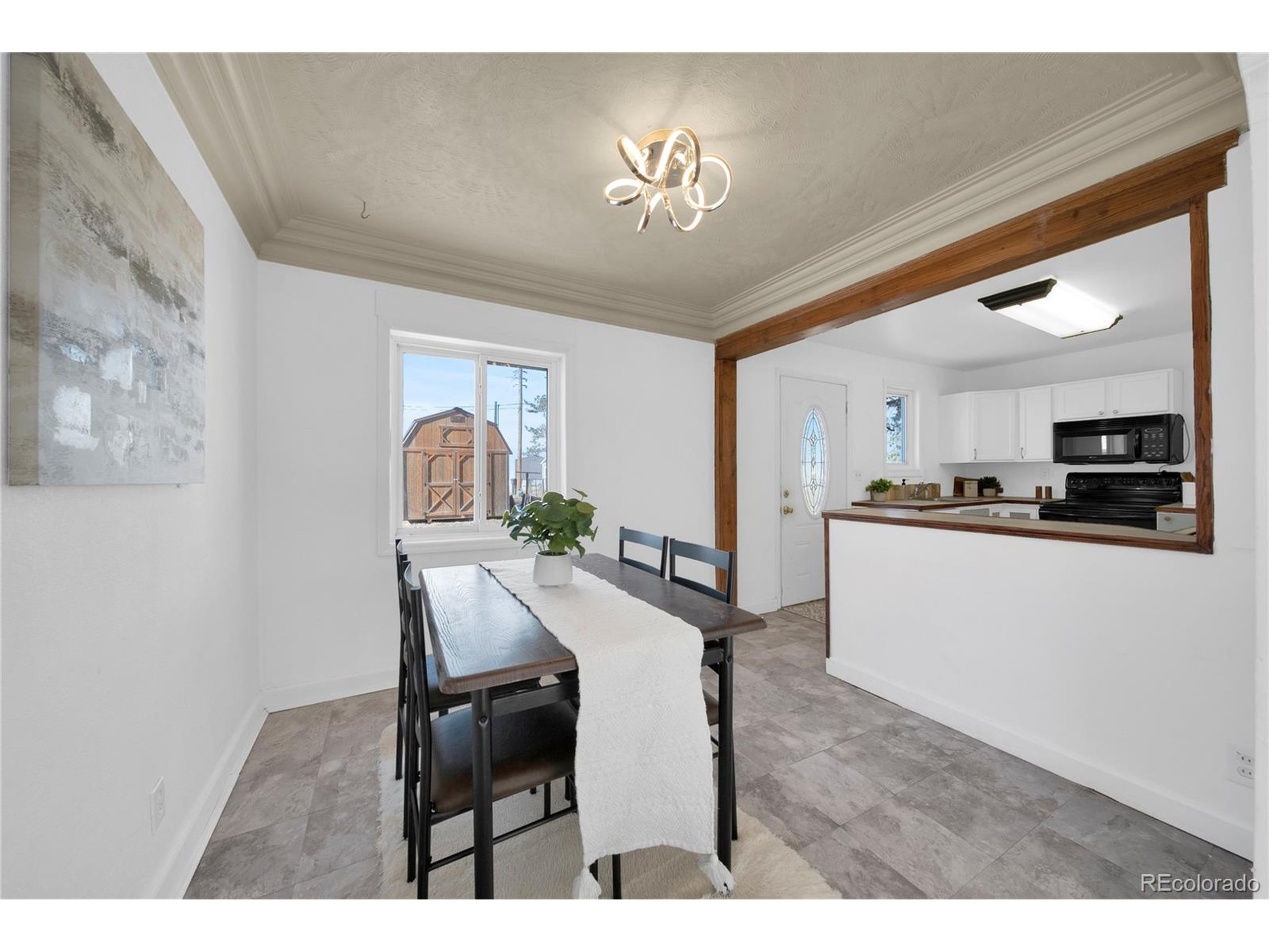 701 4th Street Akron, CO 80720 - Photo 13 of 26 a living room with furniture and a chandelier
