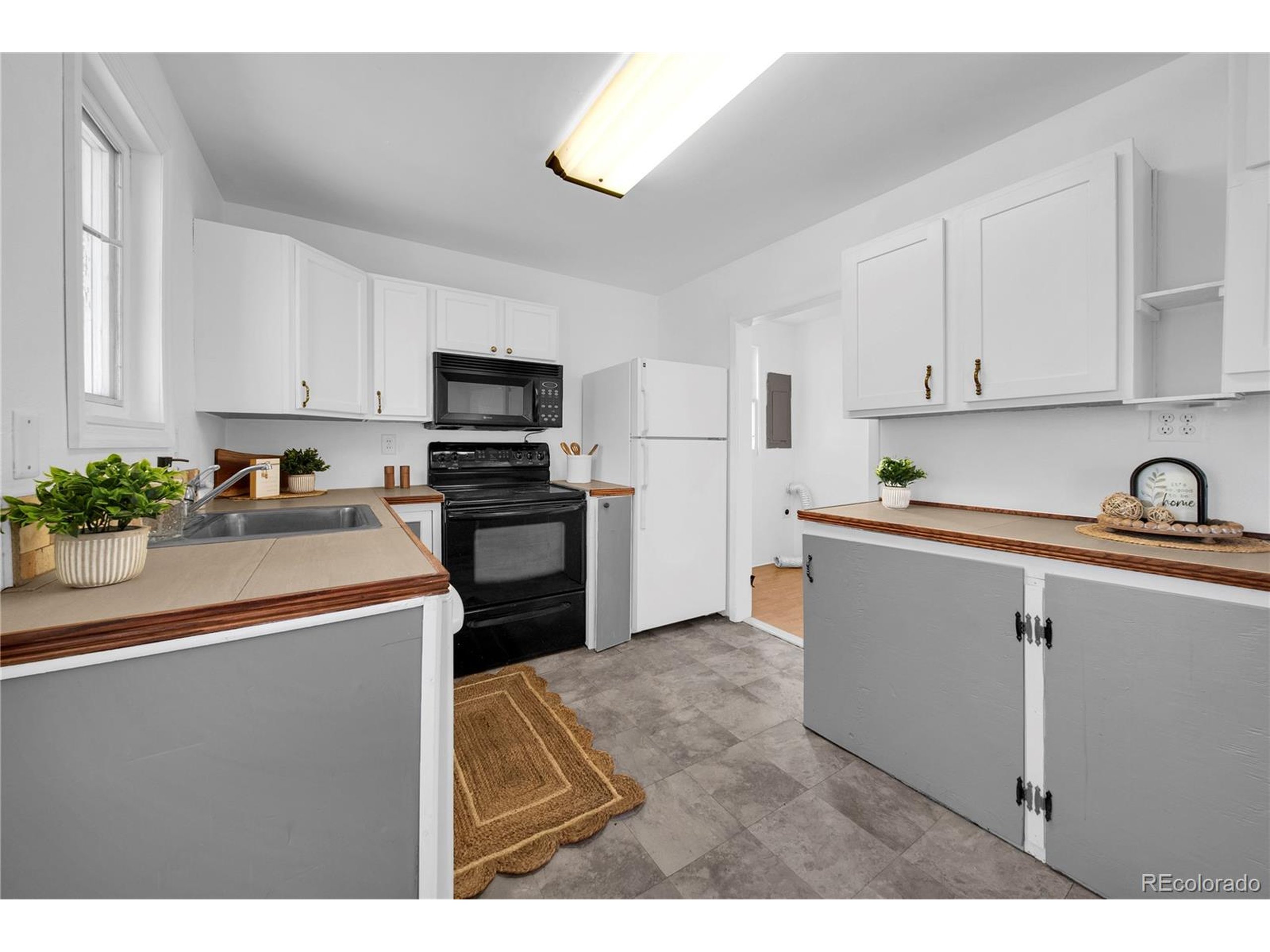 701 4th Street Akron, CO 80720 - Photo 15 of 26 a kitchen with kitchen island sink stove and refrigerator