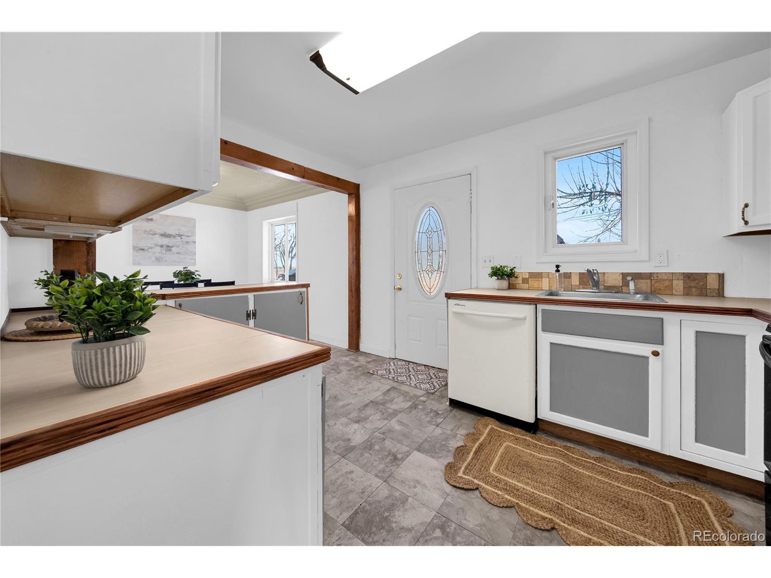 701 4th Street Akron, CO 80720 - Photo 18 of 26 a kitchen with stainless steel appliances granite countertop a sink a stove and a refrigerator