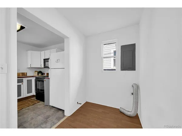 a kitchen with cabinets and refrigerator