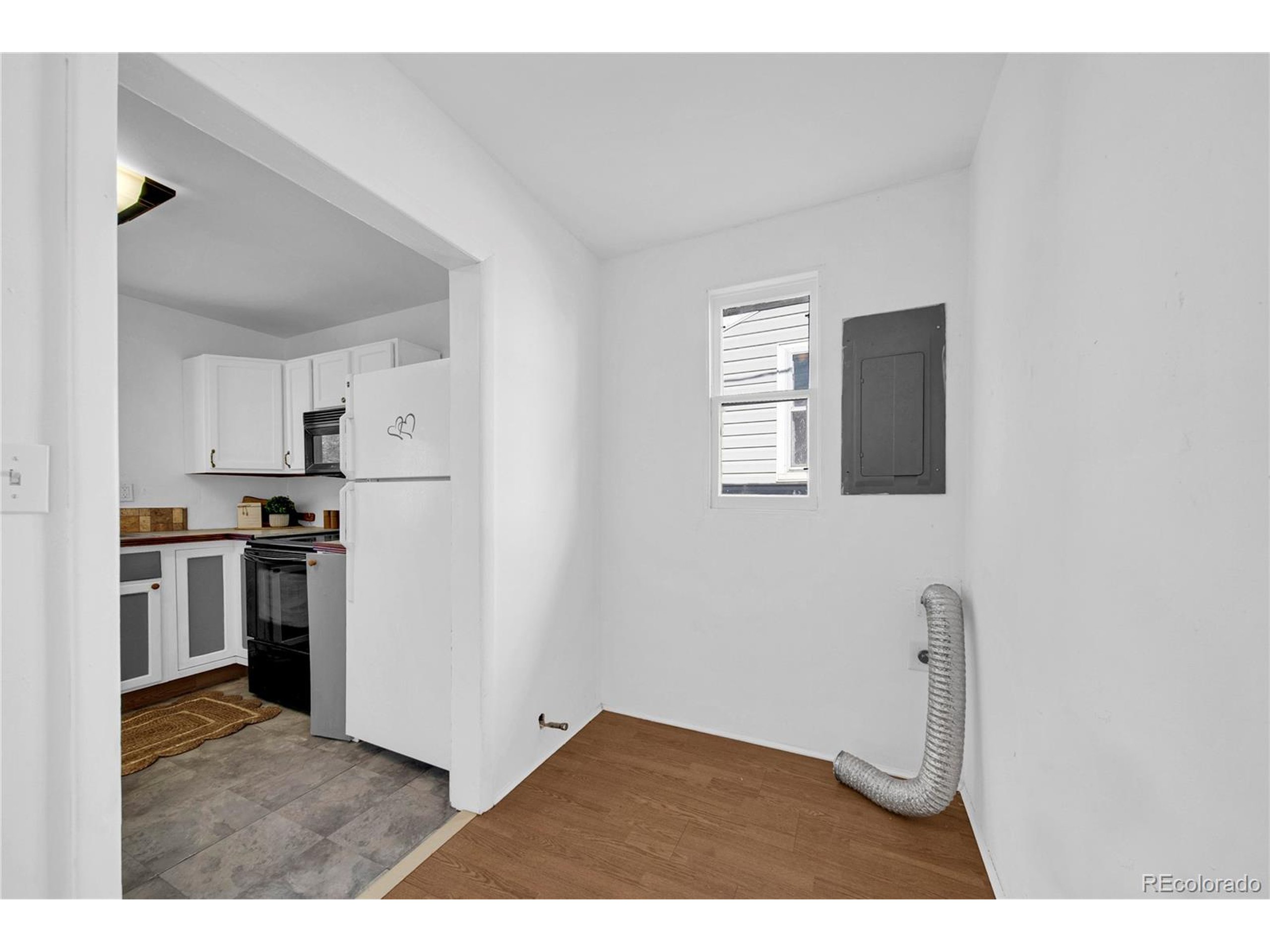 701 4th Street Akron, CO 80720 - Photo 19 of 26 a kitchen with cabinets and refrigerator