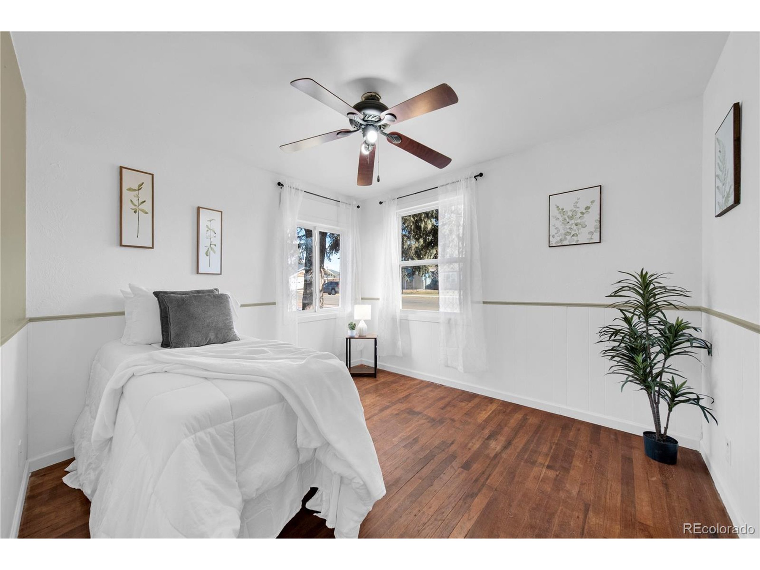 701 4th Street Akron, CO 80720 - Photo 23 of 26 a bedroom with a large bed and a chandelier