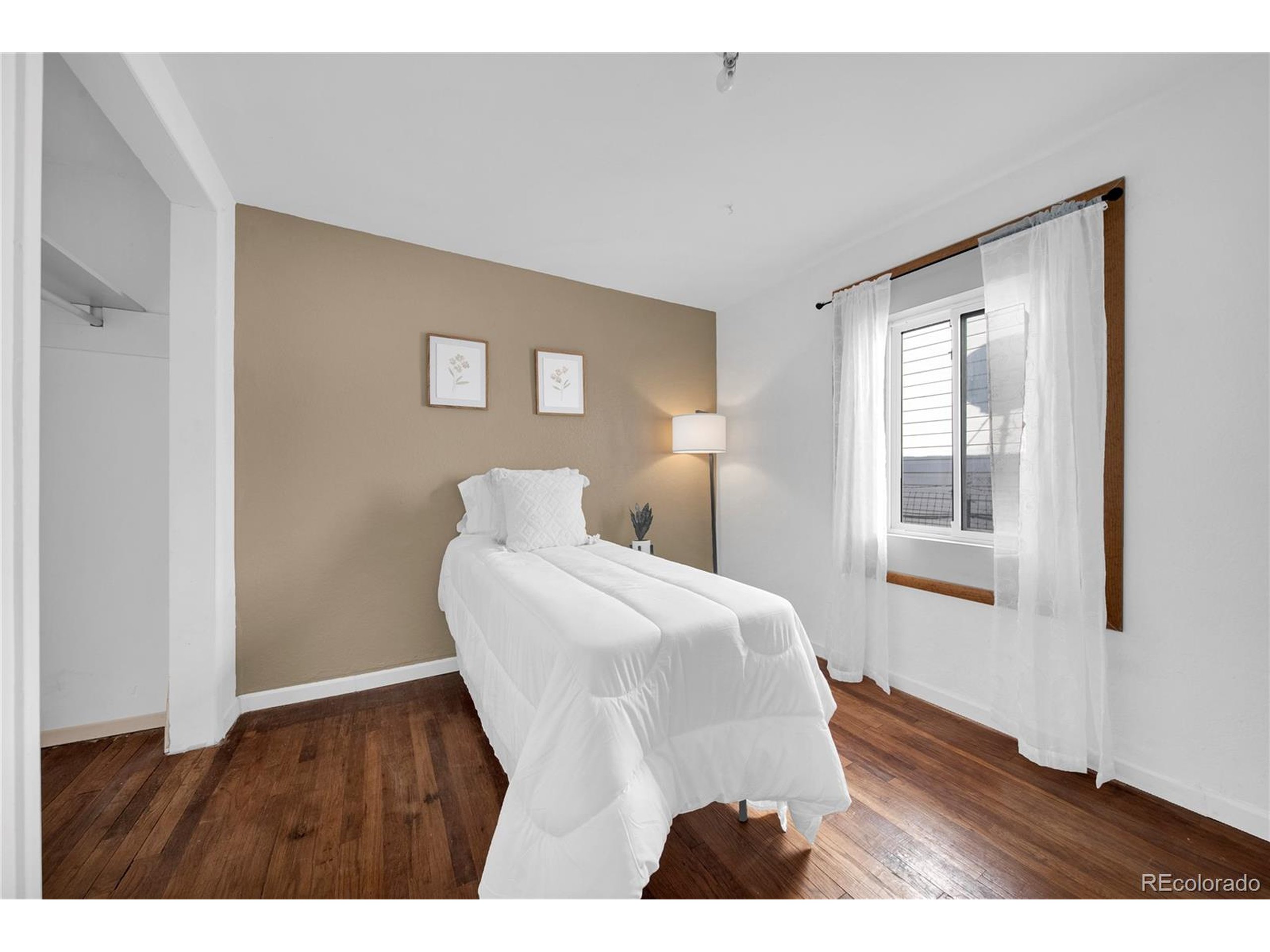 701 4th Street Akron, CO 80720 - Photo 24 of 26 a bedroom with a bed and wooden floor
