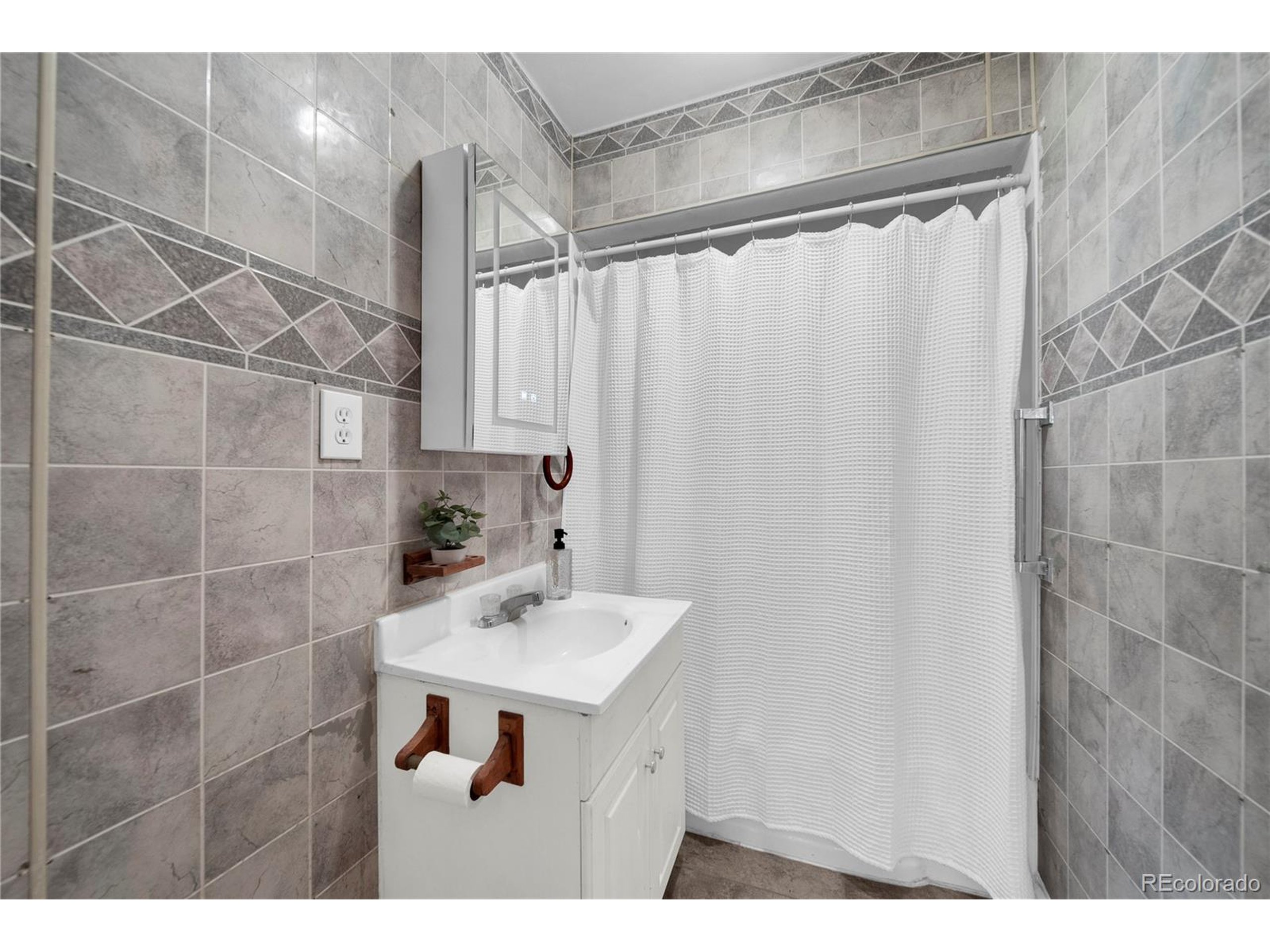 701 4th Street Akron, CO 80720 - Photo 25 of 26 a bathroom with a sink and a mirror
