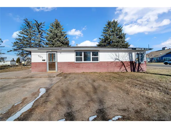 a view of a house with backyard and trees