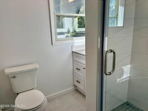 a bathroom with a toilet and a shower
