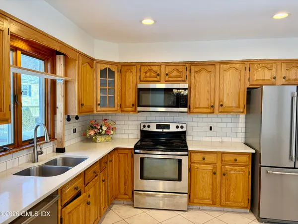 a kitchen with a sink stove and refrigerator