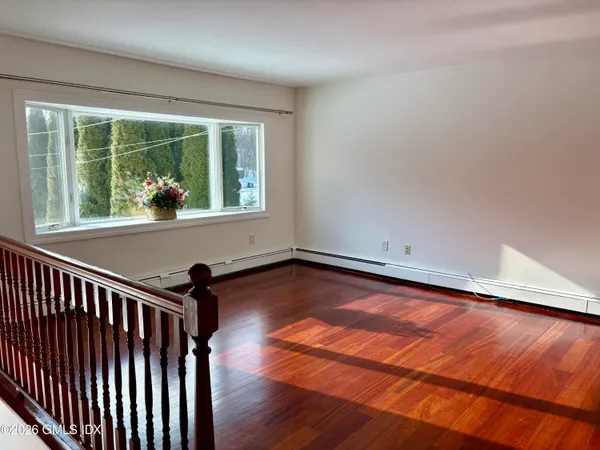 a view of a room with wooden floor and iron gate