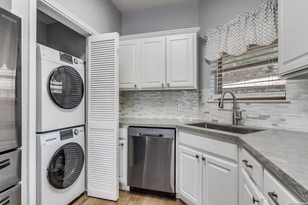 a kitchen with a sink and a washer dryer