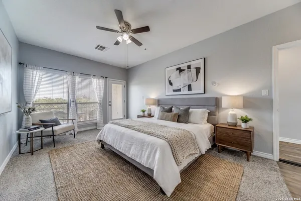 a spacious bedroom with a bed and large windows