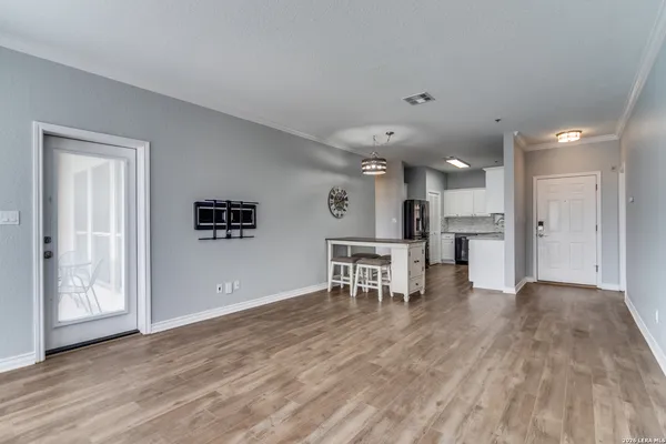 a view of a kitchen with dining room and wooden floor