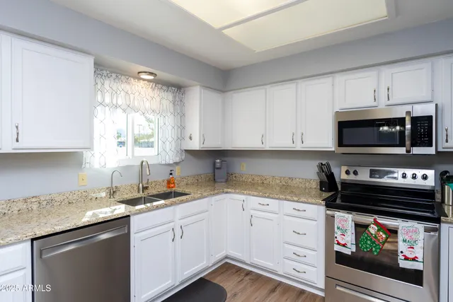 a kitchen with appliances a sink and a window