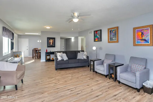 a living room with furniture and a wooden floor