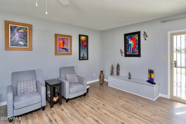 a living room with furniture and a wooden floor