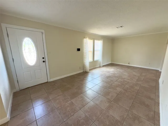 a view of a hallway with wooden cabinets