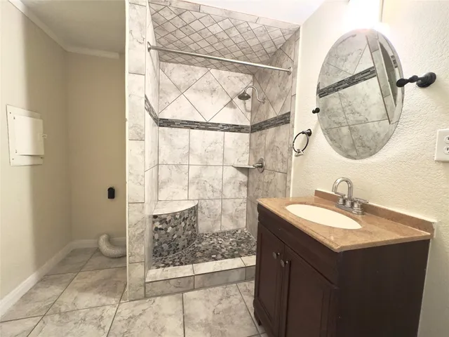 a large kitchen with cabinets and stainless steel appliances