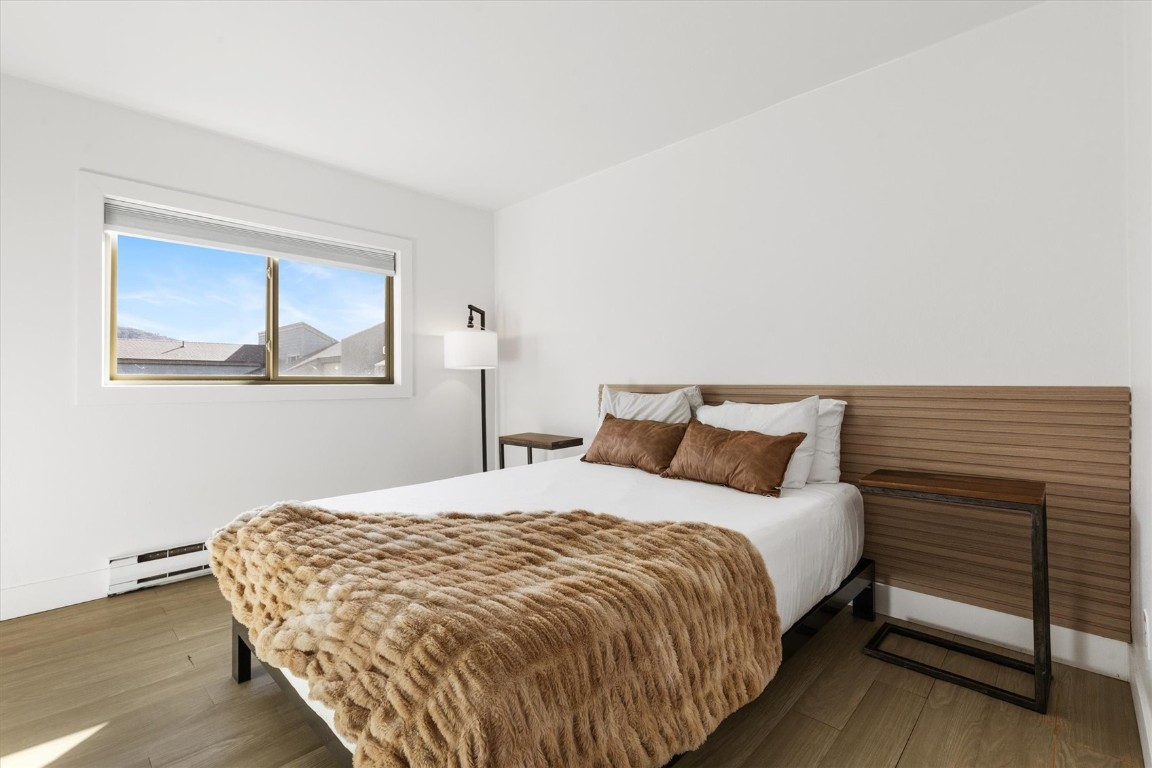 1565 Shadow Run Frontage, Unit B307 Steamboat Springs, CO 80487 - Photo 11 of 20 a bedroom with a bed and a night stand