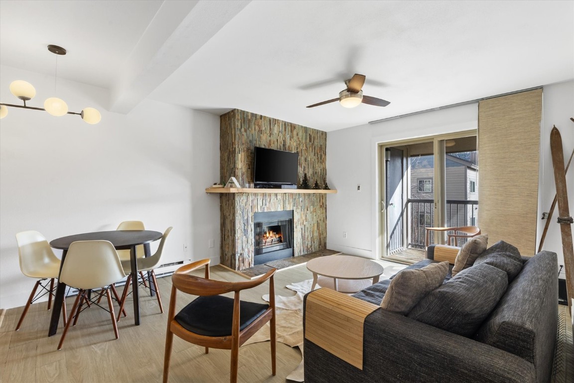 1565 Shadow Run Frontage, Unit B307 Steamboat Springs, CO 80487 - Photo 18 of 20 a living room with furniture a fireplace and a flat screen tv