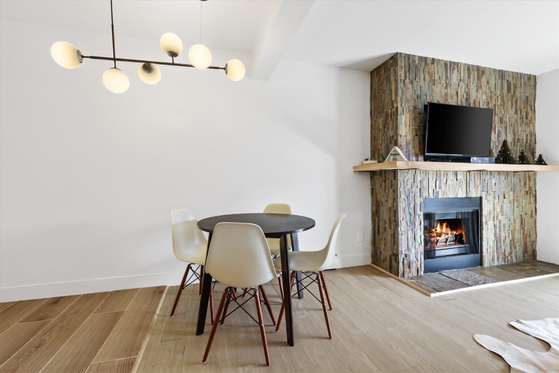 1565 Shadow Run Frontage, Unit B307 Steamboat Springs, CO 80487 - Photo 5 of 20 a living room with furniture a flat screen tv and a fireplace