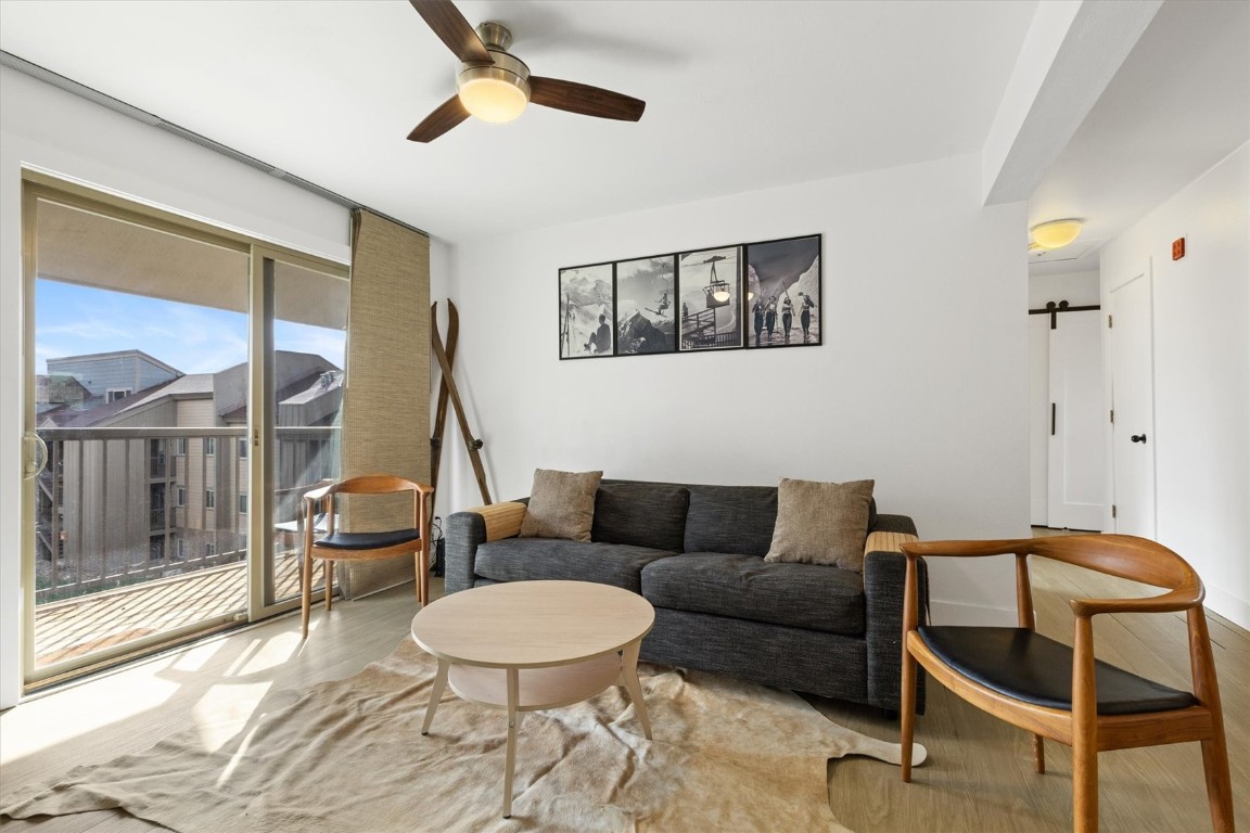 1565 Shadow Run Frontage, Unit B307 Steamboat Springs, CO 80487 - Photo 9 of 20 a living room with furniture and a floor to ceiling window