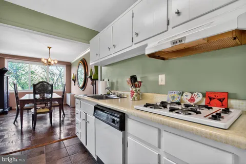 a kitchen with white cabinets and appliances