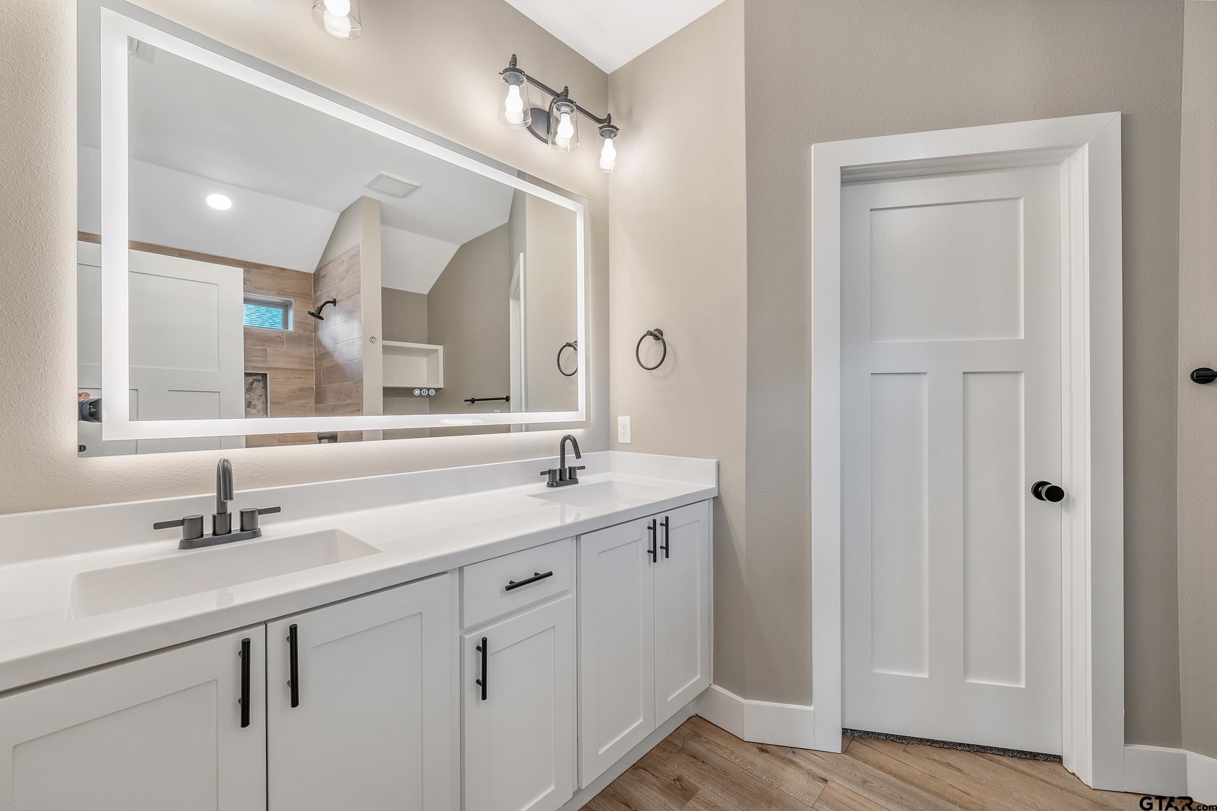 16418 Crossing Circle Lindale, TX 75771 - Photo 12 of 31 a bathroom with a double vanity sink mirror and