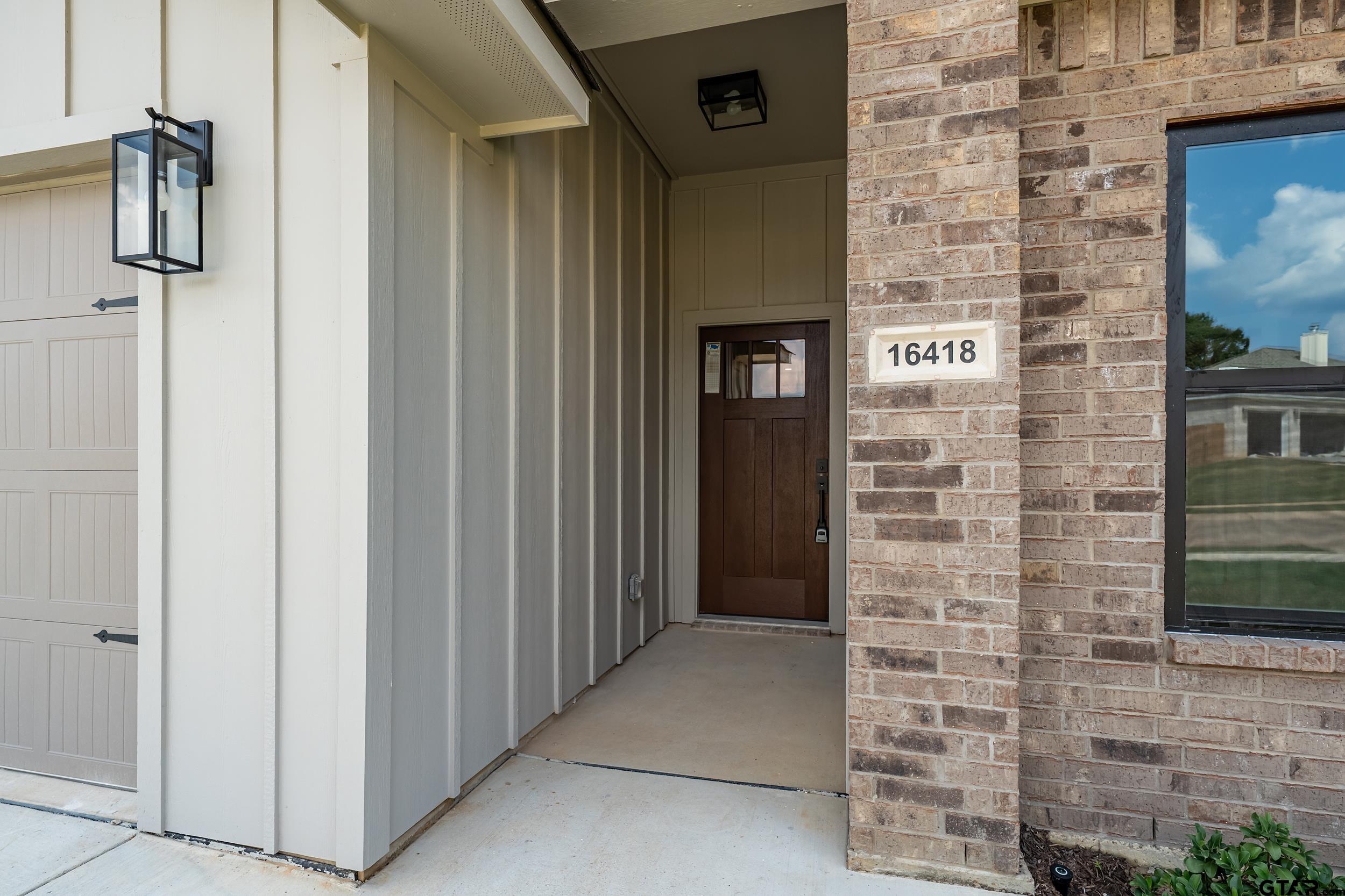 16418 Crossing Circle Lindale, TX 75771 - Photo 2 of 31 a brick building with a door and a door
