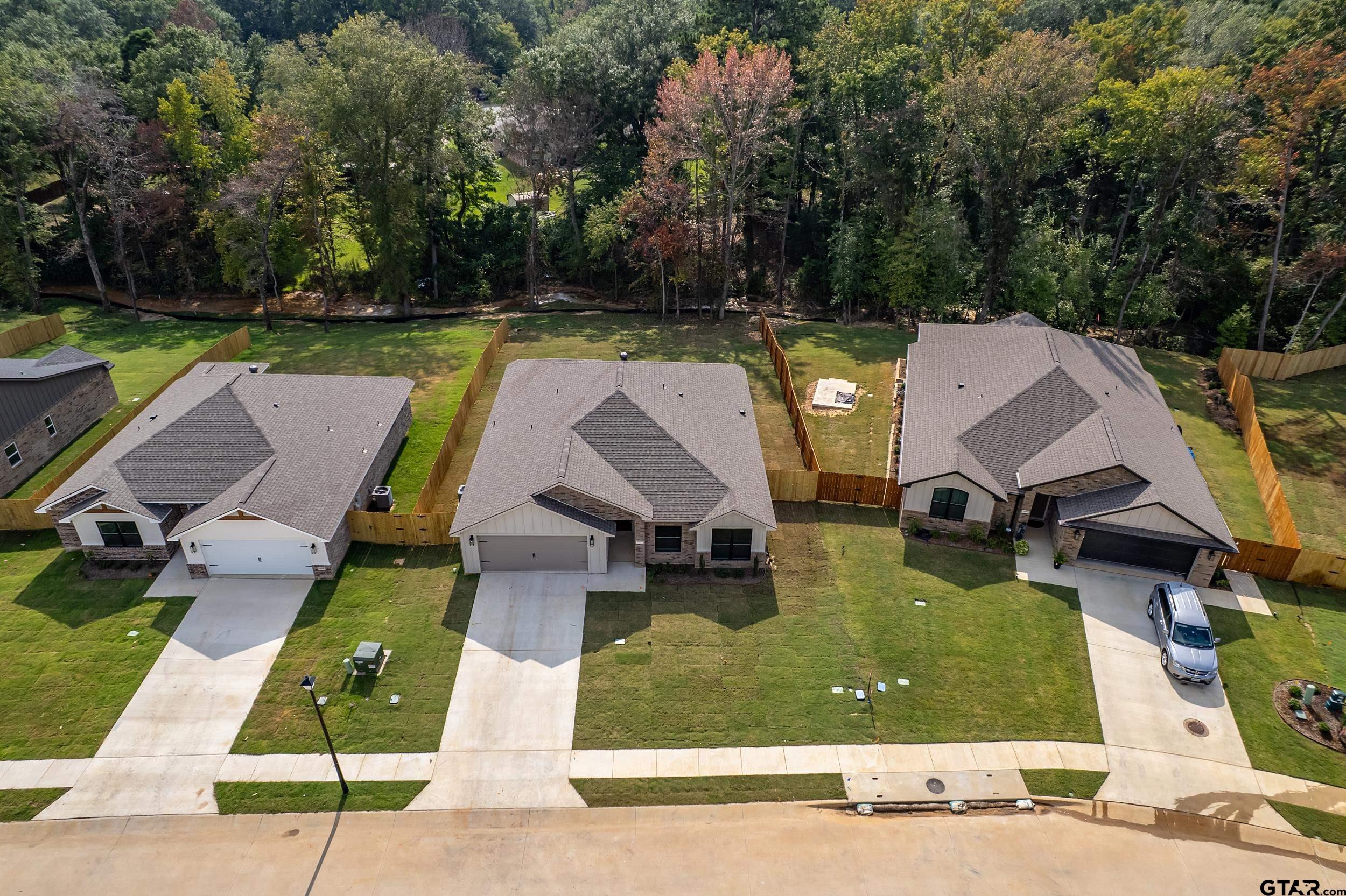 16418 Crossing Circle Lindale, TX 75771 - Photo 28 of 31 an aerial view of a house with swimming pool and garden