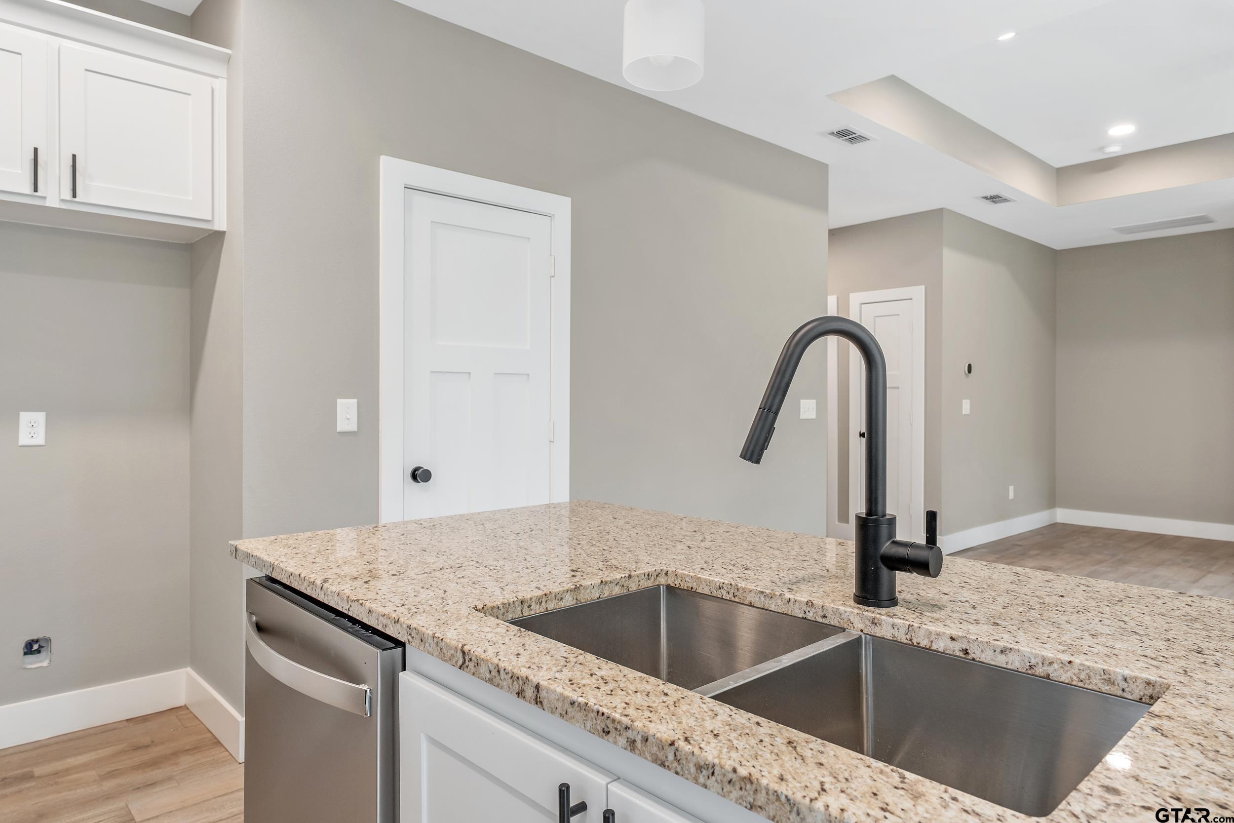 16418 Crossing Circle Lindale, TX 75771 - Photo 6 of 31 a kitchen with a sink and a refrigerator