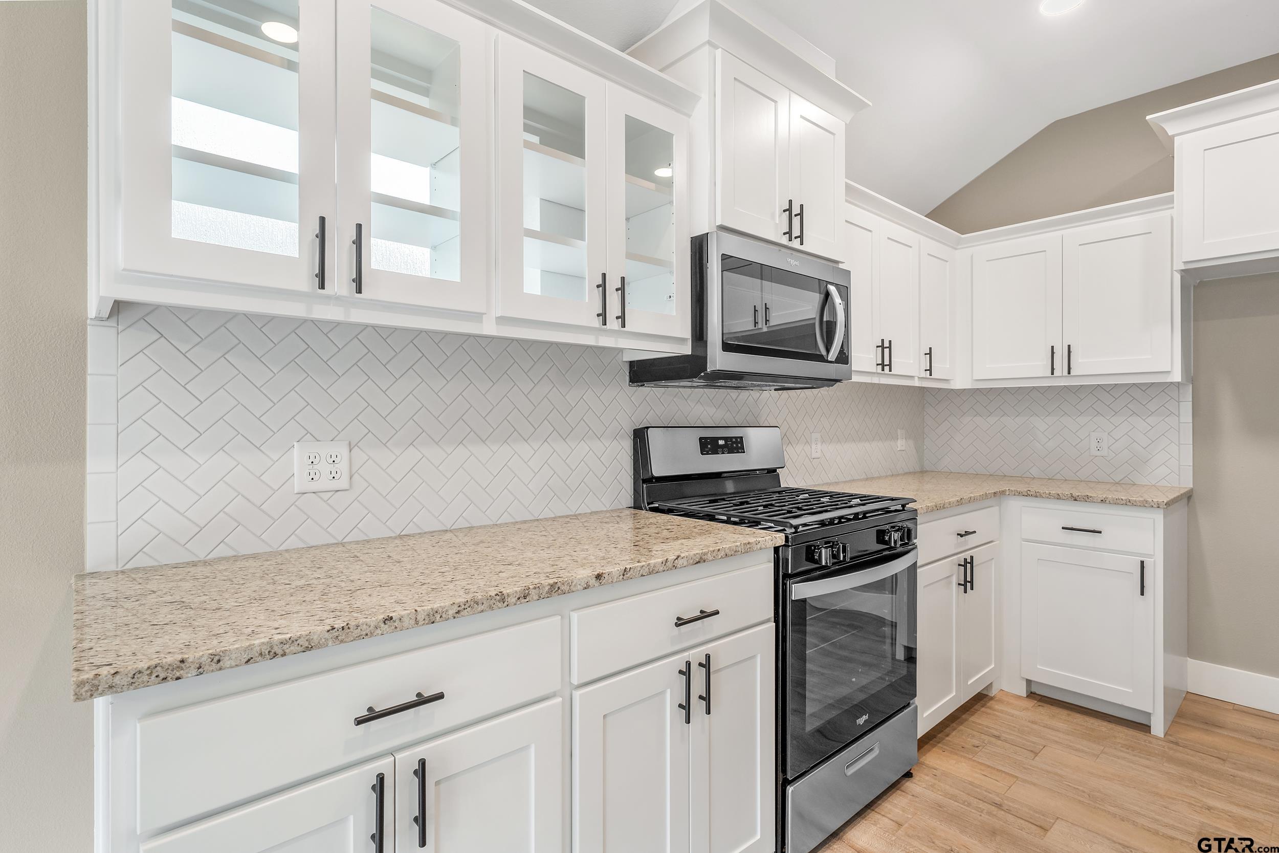 16418 Crossing Circle Lindale, TX 75771 - Photo 8 of 31 a kitchen with stainless steel appliances granite countertop white cabinets and window