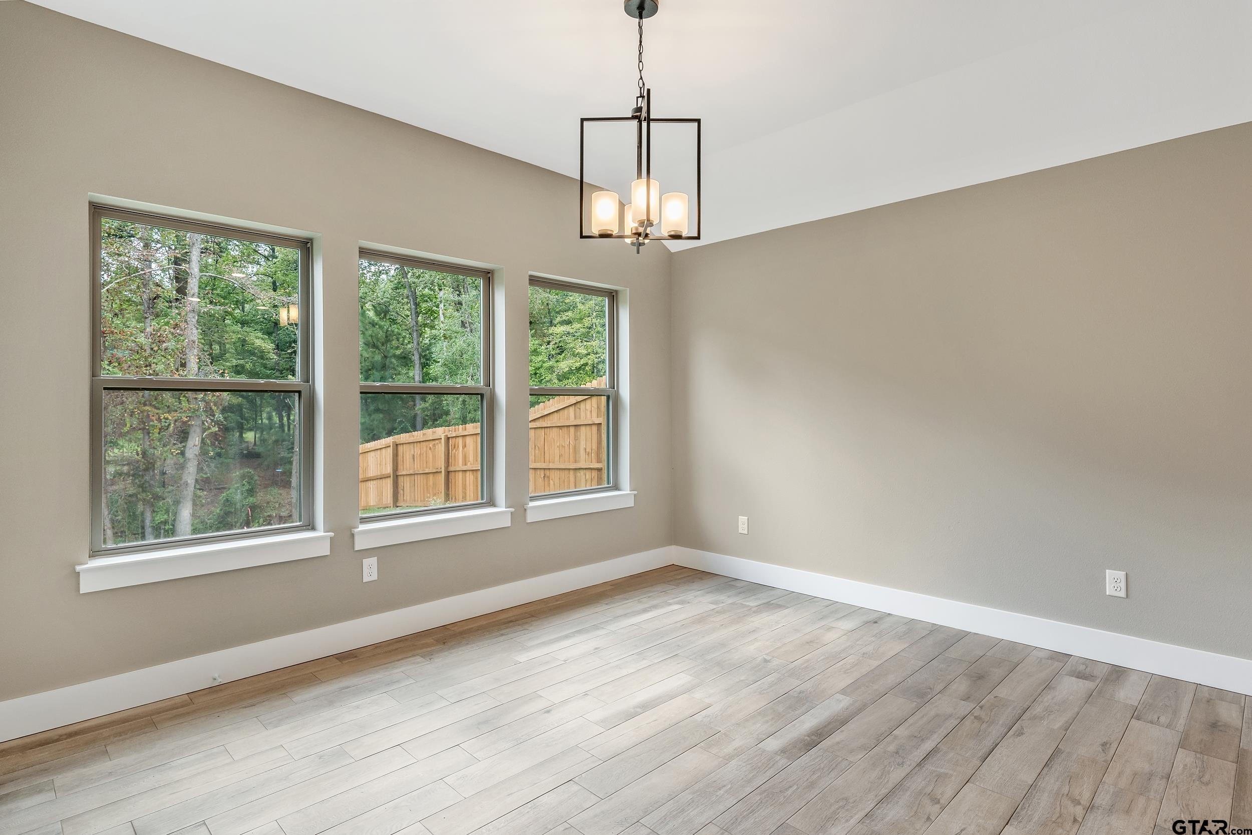 16418 Crossing Circle Lindale, TX 75771 - Photo 9 of 31 a view of an empty room with wooden floor and a window