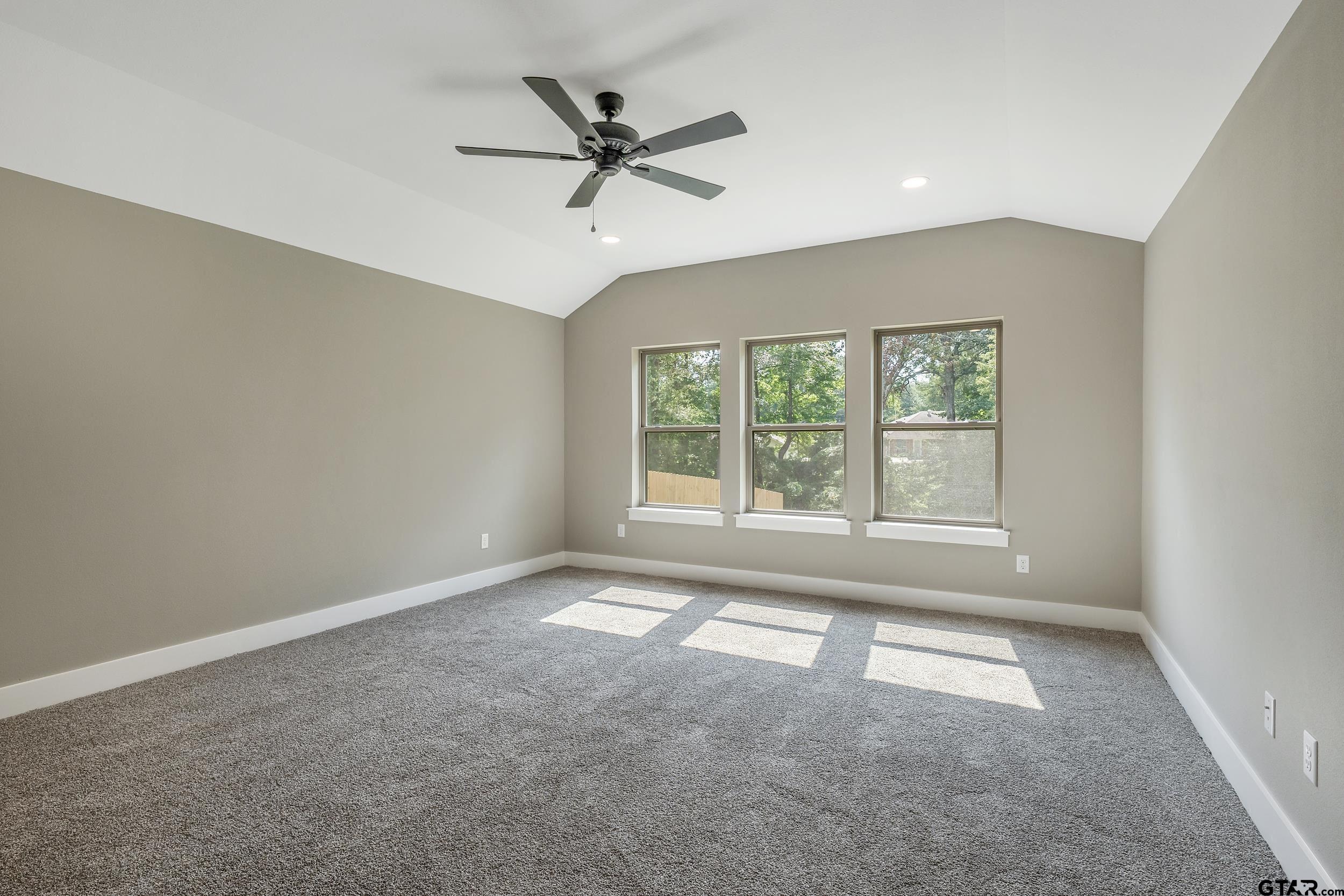 16418 Crossing Circle Lindale, TX 75771 - Photo 10 of 31 an empty room with ceiling fan and windows