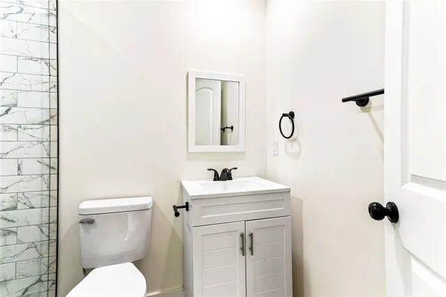 a bathroom with a sink a toilet and mirror