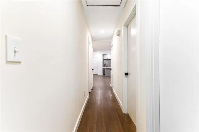 a view of a hallway with wooden floor