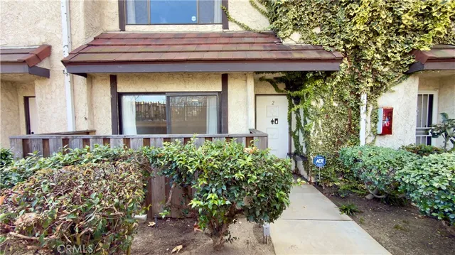 a view of a house with potted plants