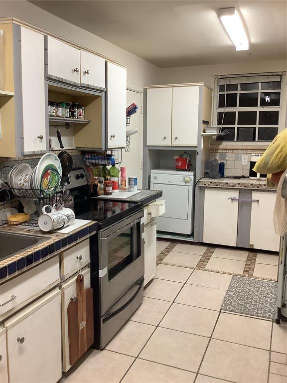 1906 Southwest 17th Court Miami, FL 33145 - Photo 14 of 33 a kitchen with a sink a stove and cabinets