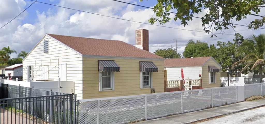1906 Southwest 17th Court Miami, FL 33145 - Photo 2 of 33 a view of a brick house with a small yard and large tree