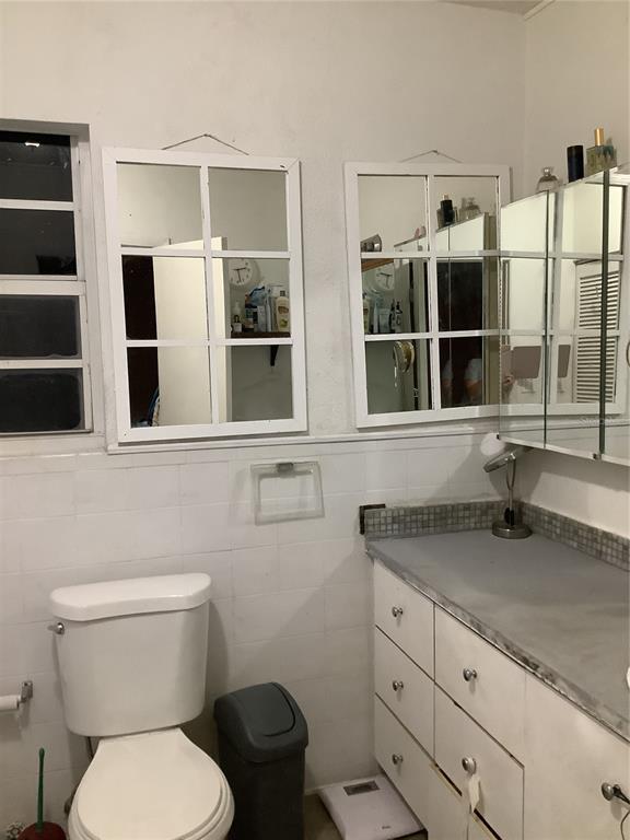 1906 Southwest 17th Court Miami, FL 33145 - Photo 28 of 33 a bathroom with a granite countertop toilet sink and shower