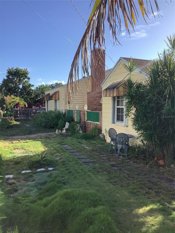 1906 Southwest 17th Court Miami, FL 33145 - Photo 7 of 33 a view of backyard with table and chairs and potted plants