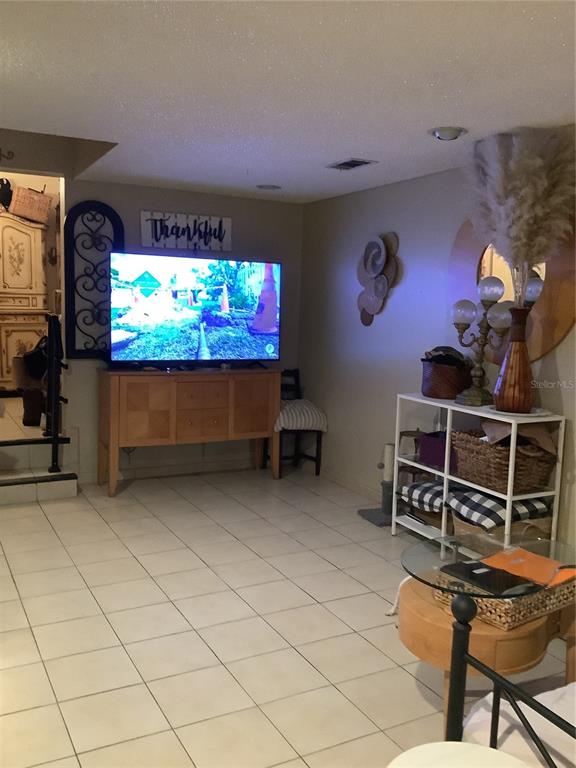 1906 Southwest 17th Court Miami, FL 33145 - Photo 9 of 33 a room with furniture a flat screen tv and a fireplace