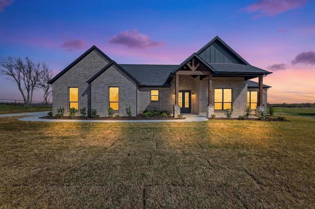4961 County Road 1098 Celeste, TX 75423 - Photo 1 of 40 View of front facade featuring a front yard, board and batten siding, brick siding, and covered porch