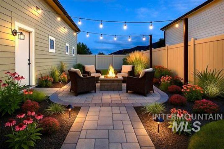 9943 West Sunberry Court Star, ID 83669 - Photo 2 of 25 Fenced backyard featuring a patio and an outdoor living space with a fire pit