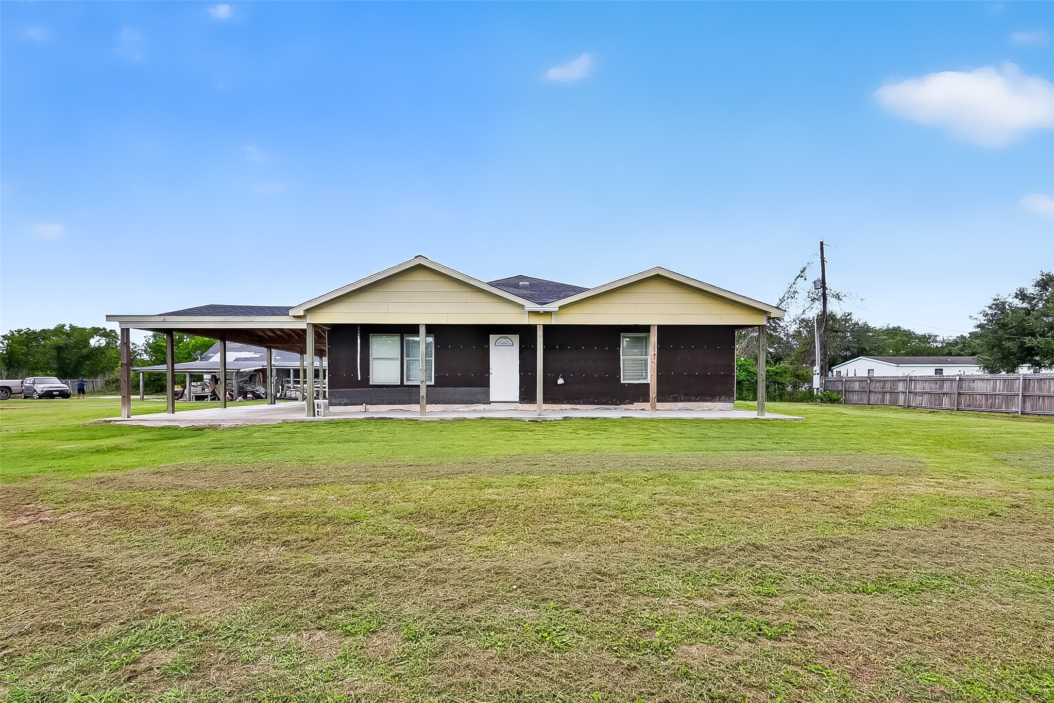 6014 Linda Drive Rosharon, TX 77583 - Photo 2 of 22 Welcome to this 3-bedroom, 2.5-bath home in the Golf View Acres community, featuring a classic symmetrical facade and a deep, full-length covered front porch.