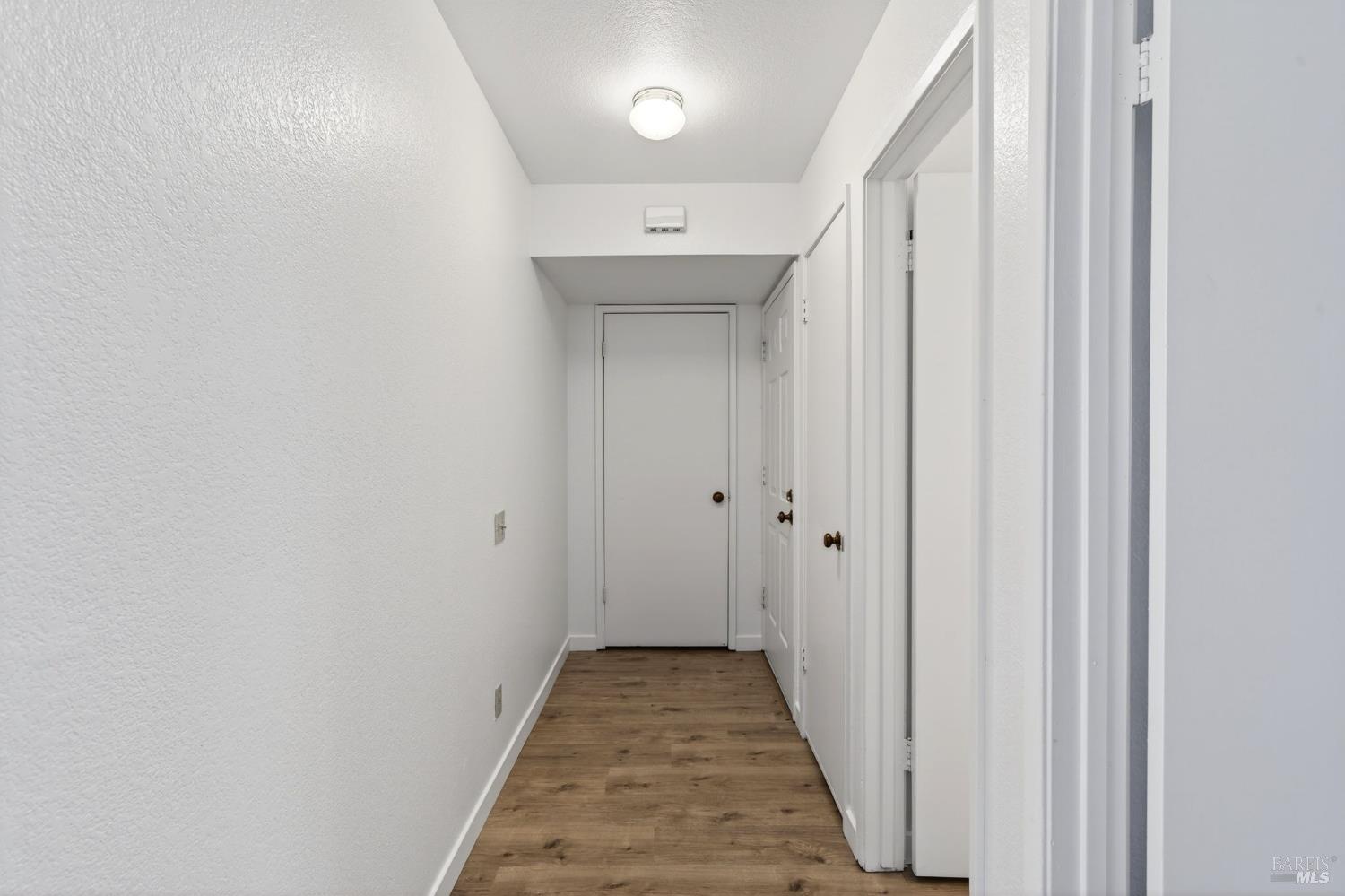 230 Courtyards East Windsor, CA 95492 - Photo 9 of 22 a view of a hallway with wooden floor